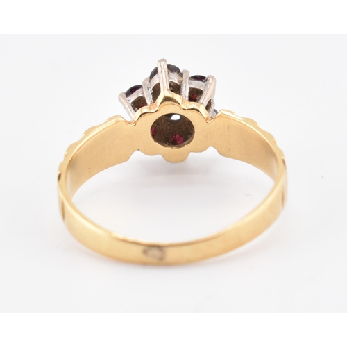 185 - An 18ct gold ruby and diamond cluster ring. The 18ct yellow gold ring having a central illusion set ... 