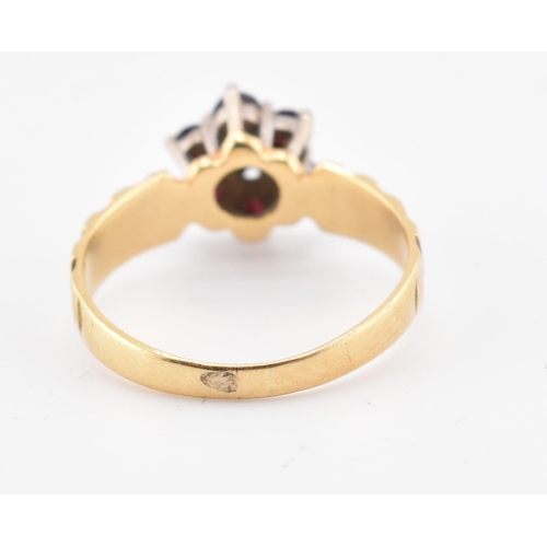 185 - An 18ct gold ruby and diamond cluster ring. The 18ct yellow gold ring having a central illusion set ... 