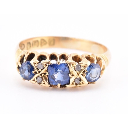 186 - An Edwardian hallmarked 18ct gold sapphire and diamond ring. The ring set with a central cushion cut... 