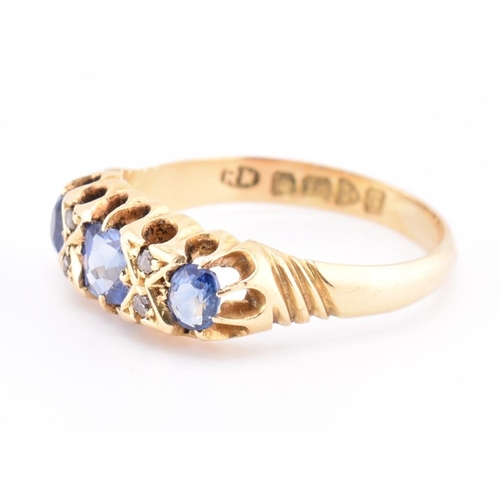 186 - An Edwardian hallmarked 18ct gold sapphire and diamond ring. The ring set with a central cushion cut... 