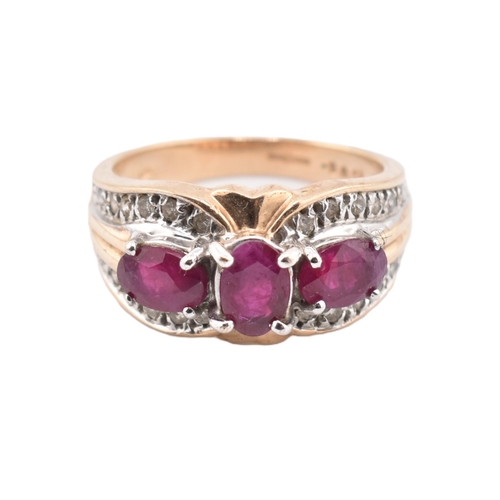 187 - A hallmarked 9ct gold ruby and diamond three stone ring. The ring set with three four claw set oval ... 