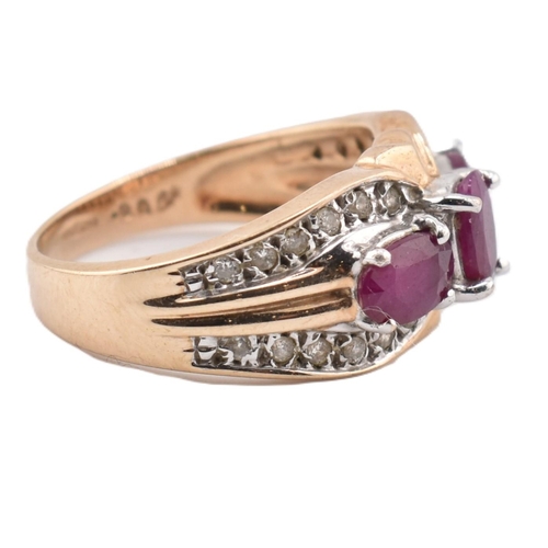 187 - A hallmarked 9ct gold ruby and diamond three stone ring. The ring set with three four claw set oval ... 