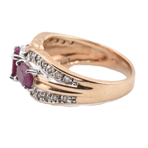 187 - A hallmarked 9ct gold ruby and diamond three stone ring. The ring set with three four claw set oval ... 