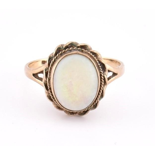 190 - A hallmarked 9ct gold and opal ring. The 9ct yellow gold ring set with a single bezel set oval opal ... 