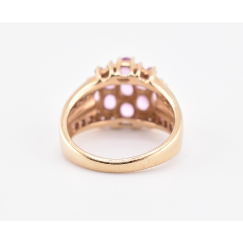 192 - A hallmarked 9ct gold pink sapphire and garnet cluster ring. The 9ct gold cluster ring set with nine... 