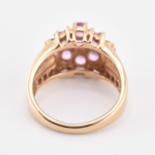 192 - A hallmarked 9ct gold pink sapphire and garnet cluster ring. The 9ct gold cluster ring set with nine... 