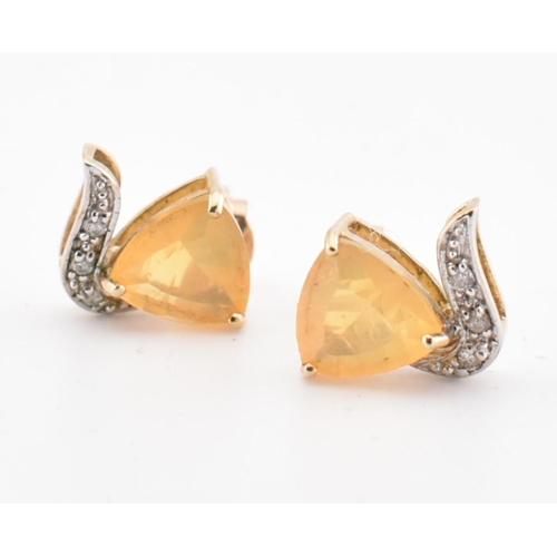 194 - A pair of hallmarked 9ct gold sunstone and diamond stud earrings. The 9ct yellow gold stud earrings ... 