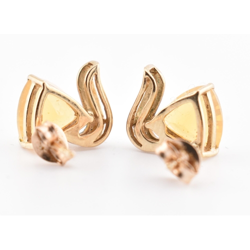 194 - A pair of hallmarked 9ct gold sunstone and diamond stud earrings. The 9ct yellow gold stud earrings ... 