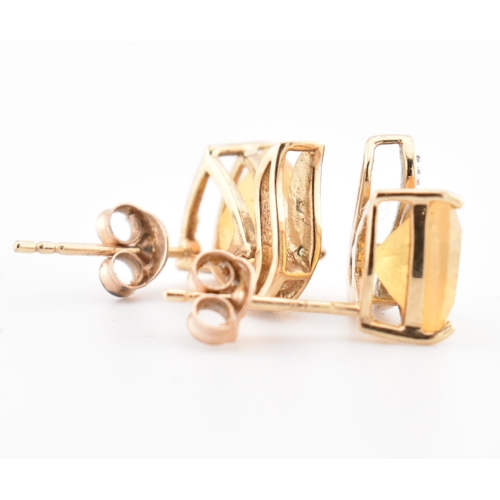 194 - A pair of hallmarked 9ct gold sunstone and diamond stud earrings. The 9ct yellow gold stud earrings ... 