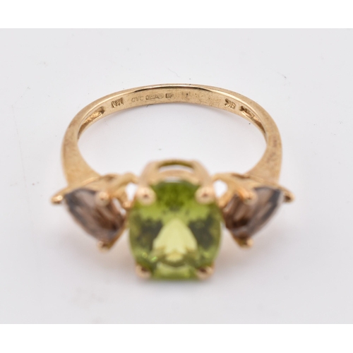 197 - A hallmarked 9ct gold changbai peridot and smoky quartz ring. The 9ct yellow gold ring set with a ce... 