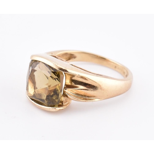 207 - A hallmarked 9ct gold and imperial topaz ring. The ring set with a single half bezel set cushion cut... 