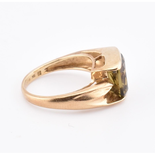 207 - A hallmarked 9ct gold and imperial topaz ring. The ring set with a single half bezel set cushion cut... 