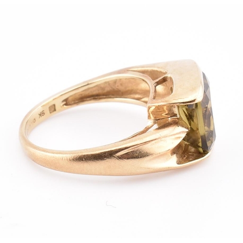 207 - A hallmarked 9ct gold and imperial topaz ring. The ring set with a single half bezel set cushion cut... 