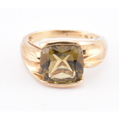 207 - A hallmarked 9ct gold and imperial topaz ring. The ring set with a single half bezel set cushion cut... 