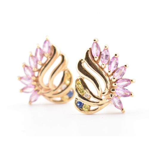 213 - A pair of hallmarked 9ct gold, pink sapphire, blue sapphire and white topaz stud earrings. The 9ct y... 