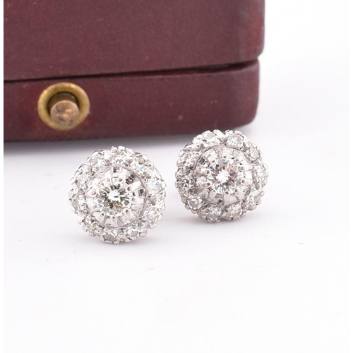 21A - A pair of diamond cluster stud earrings cased. The stud earrings set with a central claw set round b... 