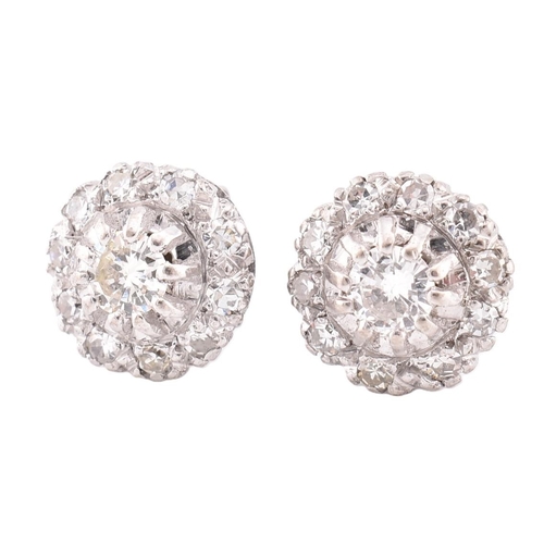 21A - A pair of diamond cluster stud earrings cased. The stud earrings set with a central claw set round b... 