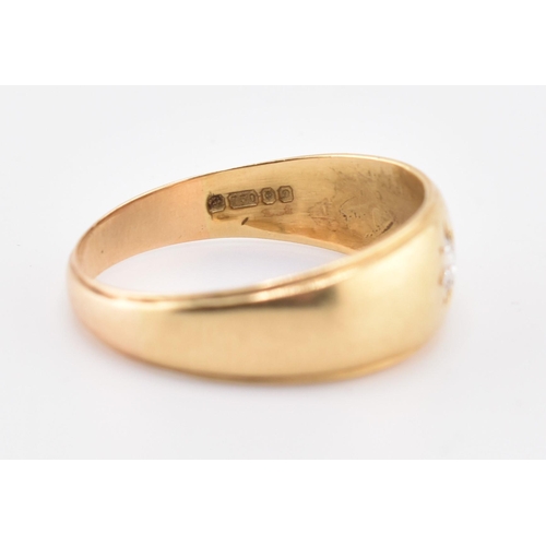 220 - A hallmarked 18ct gold and diamond band ring. The 18ct yellow gold ring set with a single star set r... 