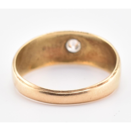 220 - A hallmarked 18ct gold and diamond band ring. The 18ct yellow gold ring set with a single star set r... 