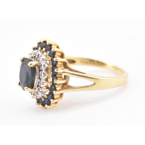 222 - A hallmarked 18ct gold sapphire and diamond cluster ring. The 18ct yellow gold ring having a central... 