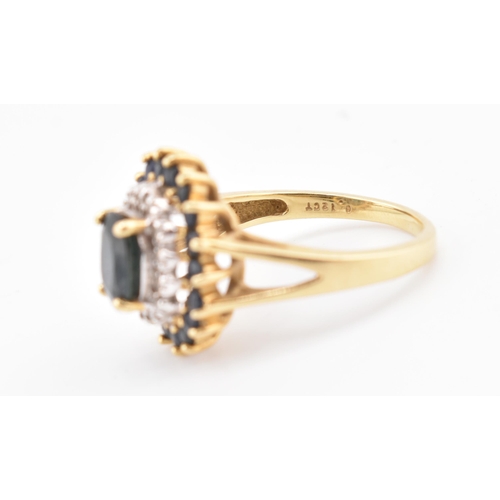 222 - A hallmarked 18ct gold sapphire and diamond cluster ring. The 18ct yellow gold ring having a central... 