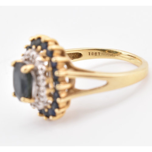 222 - A hallmarked 18ct gold sapphire and diamond cluster ring. The 18ct yellow gold ring having a central... 