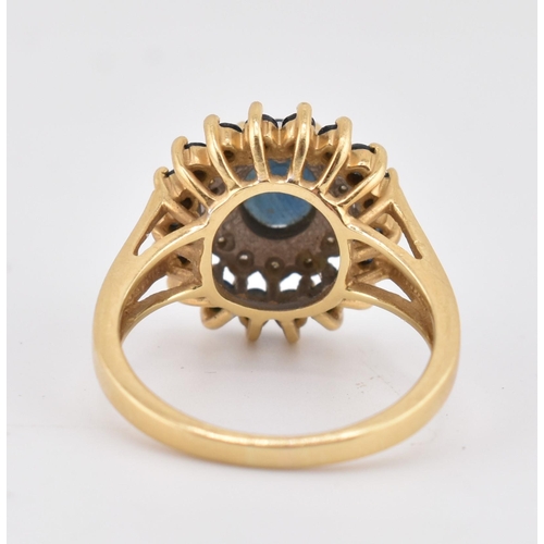 222 - A hallmarked 18ct gold sapphire and diamond cluster ring. The 18ct yellow gold ring having a central... 