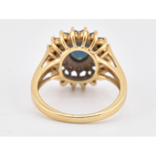 222 - A hallmarked 18ct gold sapphire and diamond cluster ring. The 18ct yellow gold ring having a central... 