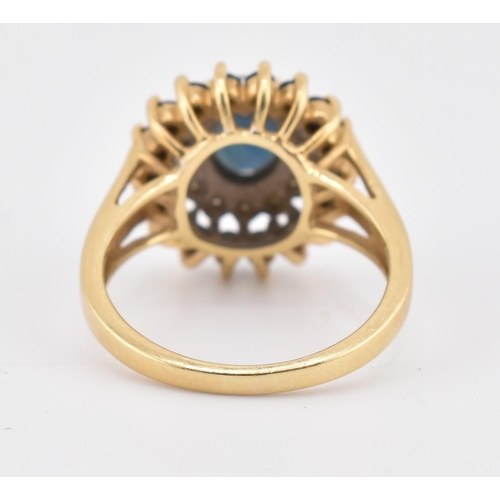 222 - A hallmarked 18ct gold sapphire and diamond cluster ring. The 18ct yellow gold ring having a central... 