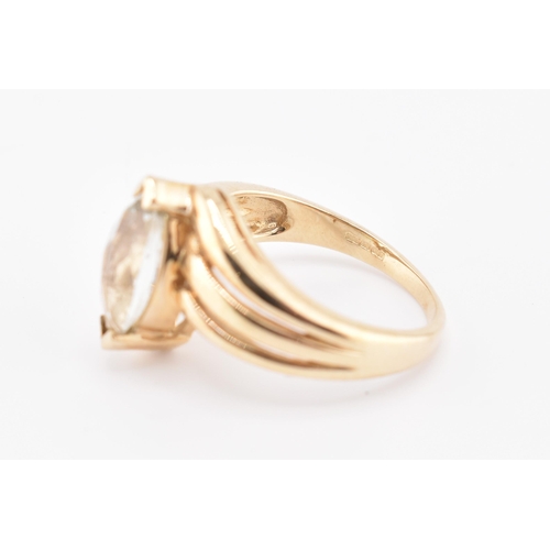 225 - A hallmarked 9ct gold and green amethyst crossover ring. The 9ct yellow gold ring set with a single ... 