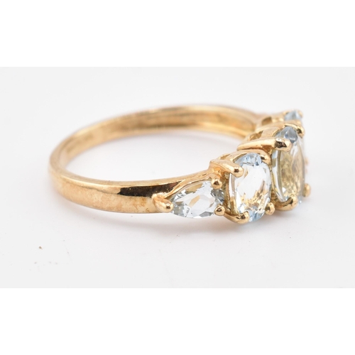 227 - A hallmarked 9ct gold aquamarine five stone ring. The 9ct yellow gold ring set with three graduating... 