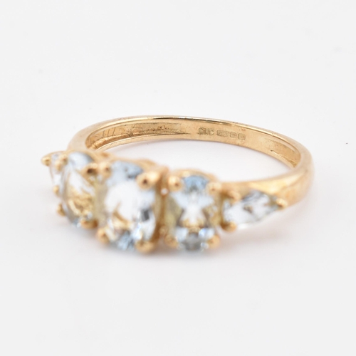 227 - A hallmarked 9ct gold aquamarine five stone ring. The 9ct yellow gold ring set with three graduating... 