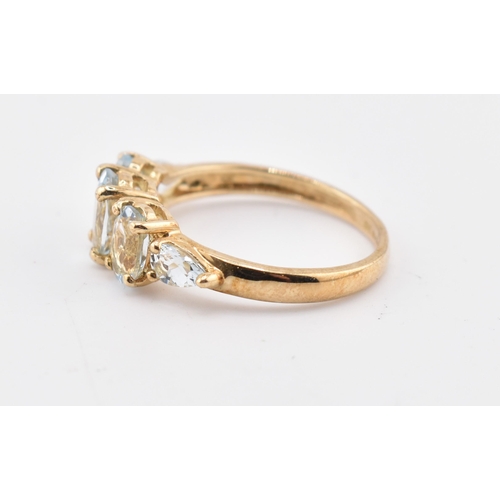 227 - A hallmarked 9ct gold aquamarine five stone ring. The 9ct yellow gold ring set with three graduating... 