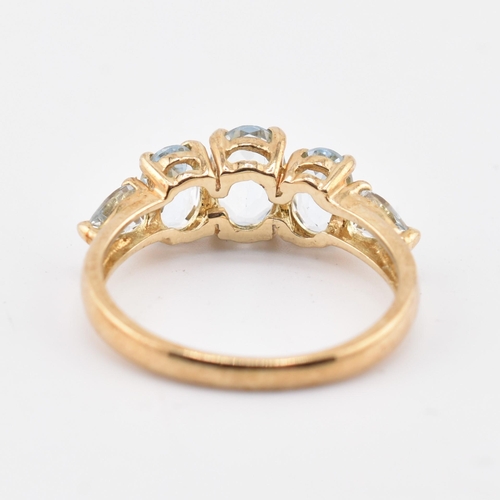 227 - A hallmarked 9ct gold aquamarine five stone ring. The 9ct yellow gold ring set with three graduating... 