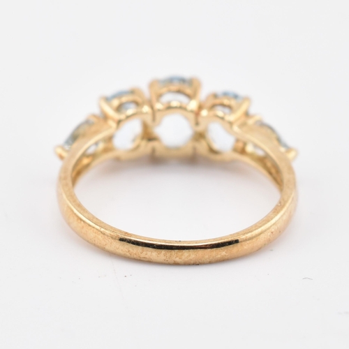 227 - A hallmarked 9ct gold aquamarine five stone ring. The 9ct yellow gold ring set with three graduating... 