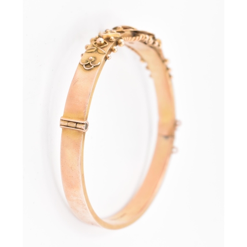 23 - An early 20th century hallmarked 9ct gold and diamond hinged bangle. The bangle set with a central o... 