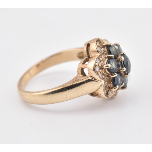 230 - A 9ct gold, sapphire and diamond cluster ring. The 9ct yellow gold ring set with seven round cut sap... 