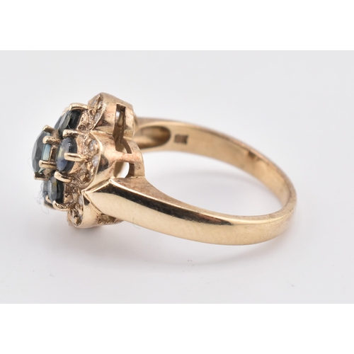 230 - A 9ct gold, sapphire and diamond cluster ring. The 9ct yellow gold ring set with seven round cut sap... 