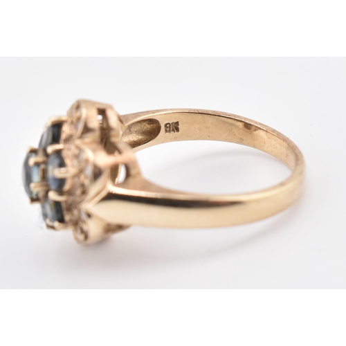 230 - A 9ct gold, sapphire and diamond cluster ring. The 9ct yellow gold ring set with seven round cut sap... 