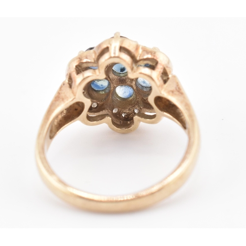 230 - A 9ct gold, sapphire and diamond cluster ring. The 9ct yellow gold ring set with seven round cut sap... 