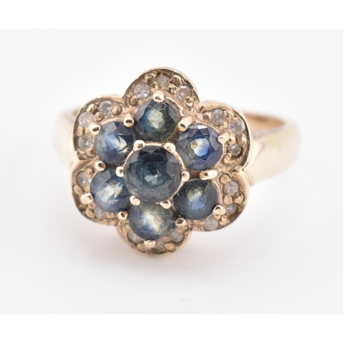 230 - A 9ct gold, sapphire and diamond cluster ring. The 9ct yellow gold ring set with seven round cut sap... 