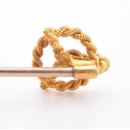 231 - A hallmarked 22ct gold band ring and a 15ct gold knot topped tie pin. The hallmarked 22ct yellow gol... 