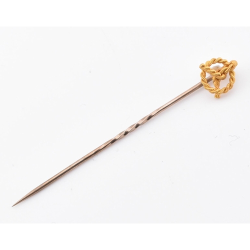 231 - A hallmarked 22ct gold band ring and a 15ct gold knot topped tie pin. The hallmarked 22ct yellow gol... 