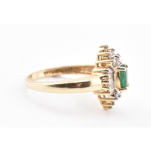 232 - A 14ct gold emerald and diamond halo cluster ring. The 14ct yellow gold ring set with a central oval... 