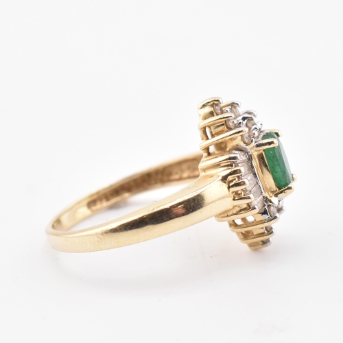 232 - A 14ct gold emerald and diamond halo cluster ring. The 14ct yellow gold ring set with a central oval... 