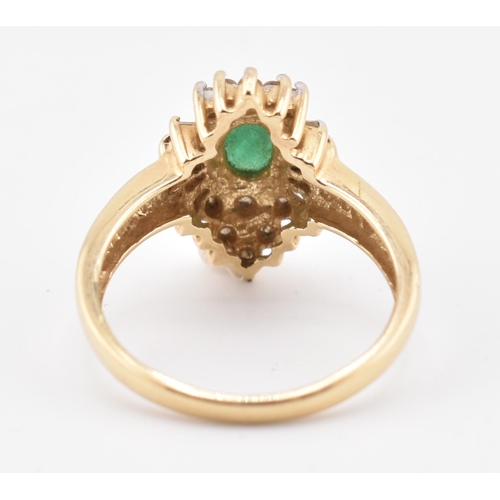 232 - A 14ct gold emerald and diamond halo cluster ring. The 14ct yellow gold ring set with a central oval... 