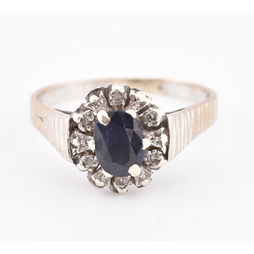 237 - A hallmarked 9ct gold sapphire and diamond cluster ring. The 9ct yellow gold ring set with a central... 