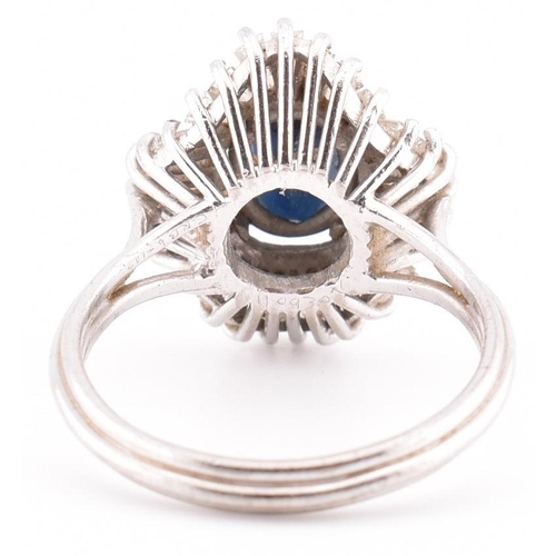 23A - An 18ct white gold sapphire and diamond ballerina cluster ring. The 18ct white gold ring set with a ... 