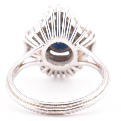 23A - An 18ct white gold sapphire and diamond ballerina cluster ring. The 18ct white gold ring set with a ... 