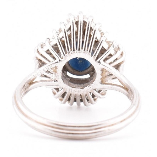 23A - An 18ct white gold sapphire and diamond ballerina cluster ring. The 18ct white gold ring set with a ... 